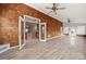 Sunroom with wood paneled walls, wood-look floors, and exterior access to the backyard at 2545 Rea Rd, Charlotte, NC 28226