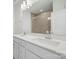 Bright bathroom features a double sink vanity with a large mirror and tiled walk-in shower at 4018 Capital Ridge Ct, Charlotte, NC 28205