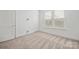 Bright, carpeted bedroom with white walls, well-lit windows, and trim, creating a simple and inviting space at 4018 Capital Ridge Ct, Charlotte, NC 28205