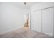 A light-filled bedroom boasts plush carpeting and a closet with sliding doors at 4018 Capital Ridge Ct, Charlotte, NC 28205