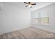 Bedroom features neutral carpet, ceiling fan, double hung windows, and white walls at 4018 Capital Ridge Ct, Charlotte, NC 28205