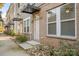 Charming townhome entrance with brick facade, manicured landscaping, and a modern black awning over the front door at 4018 Capital Ridge Ct, Charlotte, NC 28205