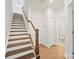 Hallway with wood staircase and a view of a half-bath at 4018 Capital Ridge Ct, Charlotte, NC 28205