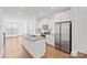 Modern kitchen featuring stainless steel appliances, a large center island, white cabinets, and hardwood floors at 4018 Capital Ridge Ct, Charlotte, NC 28205