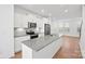 Bright kitchen with white cabinets, stainless steel appliances, gray countertop and large island at 4018 Capital Ridge Ct, Charlotte, NC 28205