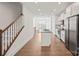 Modern kitchen features stainless steel appliances, white cabinetry, and an island with a sink at 4018 Capital Ridge Ct, Charlotte, NC 28205