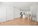 Bright open-concept living space with hardwood floors, white walls, and a modern kitchen in the background at 4018 Capital Ridge Ct, Charlotte, NC 28205