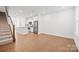 Spacious living area with hardwood floors, flowing into the modern kitchen with stainless appliances and island at 4018 Capital Ridge Ct, Charlotte, NC 28205