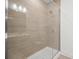 Close-up of a tiled shower with frameless glass doors and a shower head at 4018 Capital Ridge Ct, Charlotte, NC 28205