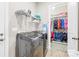 Laundry room with washer, dryer, shelving, and adjacent closet at 131 Chimney Rock Ct, Denver, NC 28037