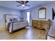Spacious bedroom with wood floors, dresser, and large bed at 4609 Coronado Dr # O, Charlotte, NC 28212