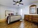 Spacious bedroom with wood floors, dresser, and large bed at 4609 Coronado Dr # O, Charlotte, NC 28212