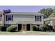 Tan siding duplex with two front doors, landscaping, and a brick base at 4609 Coronado Dr # O, Charlotte, NC 28212