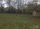View of the yard showcasing lush green grass and a shed in the corner of the lot at 605 N Mcfarland N St, Gastonia, NC 28054