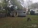 Backyard view of the home with new wooden stairs leading to the elevated entrance at 605 N Mcfarland N St, Gastonia, NC 28054