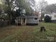 Backyard view of the home featuring the well-maintained lawn at 605 N Mcfarland N St, Gastonia, NC 28054