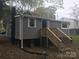 Backyard view of the home with new wooden stairs leading to the elevated entrance at 605 N Mcfarland N St, Gastonia, NC 28054
