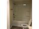 Bathroom showcasing a tub and shower combo, toilet, and wood flooring at 605 N Mcfarland N St, Gastonia, NC 28054