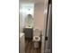 Bathroom features a toilet, vanity, light fixture, and hardwood flooring at 605 N Mcfarland N St, Gastonia, NC 28054
