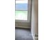 Corner bedroom with neutral walls, grey carpet, and natural light from the window at 605 N Mcfarland N St, Gastonia, NC 28054