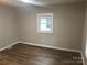 Bedroom featuring wood floors, gray walls, and a window at 605 N Mcfarland N St, Gastonia, NC 28054