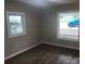 Bedroom with hardwood floors, gray walls, and new windows at 605 N Mcfarland N St, Gastonia, NC 28054
