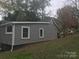 Home exterior featuring gray siding, white trim, and well-maintained landscaping at 605 N Mcfarland N St, Gastonia, NC 28054