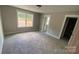 Neutral bedroom boasts a window, plush carpeting, and two doorways enhancing the open, airy feel at 217 Heartland Dr, Rock Hill, SC 29732