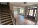 Elegant entryway showcases wood floors, staircase, dining room and striking front door at 217 Heartland Dr, Rock Hill, SC 29732