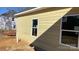 View of the back of house showing its light-yellow siding and several windows at 217 Heartland Dr, Rock Hill, SC 29732