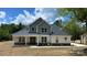 New construction home with a two-tone color scheme, stone accents, and a covered front porch at 217 Heartland Dr, Rock Hill, SC 29732