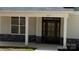 Close up of the front door with sidelights and a stone accent wall and visible house number at 217 Heartland Dr, Rock Hill, SC 29732