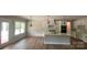 Bright kitchen and dining area with white cabinets, quartz countertops and stainless appliances at 217 Heartland Dr, Rock Hill, SC 29732