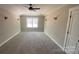 Large main bedroom with tray ceiling, fan, sconces, and plenty of natural light at 217 Heartland Dr, Rock Hill, SC 29732