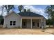 Home's back porch with stately white columns and neutral colored siding at 227 Heartland Dr, Rock Hill, SC 29732