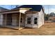 Framing view of a new home showcasing the covered patio and window placements at 227 Heartland Dr, Rock Hill, SC 29732