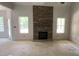 Unfinished living room features a stone fireplace and natural light at 227 Heartland Dr, Rock Hill, SC 29732