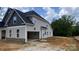 Exterior side view of the home featuring an attached garage and neutral siding at 227 Heartland Dr, Rock Hill, SC 29732