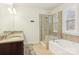 Bathroom with double vanity, shower, and bathtub at 2624 Woodlands Creek Dr, Monroe, NC 28110