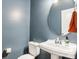 Small powder room with pedestal sink and blue walls at 2624 Woodlands Creek Dr, Monroe, NC 28110