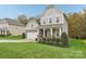 Two-story house with gray siding, stone accents, and a landscaped lawn at 2624 Woodlands Creek Dr, Monroe, NC 28110