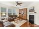 Spacious living room with hardwood floors, fireplace, and built-in shelving at 2624 Woodlands Creek Dr, Monroe, NC 28110