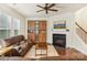 Spacious living room with hardwood floors, fireplace, and built-in shelving at 2624 Woodlands Creek Dr, Monroe, NC 28110