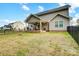 Home backyard with covered patio, fence, and fire pit at 3018 Corinth Church Rd, Monroe, NC 28112