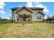 Home backyard with covered patio, fence, and fire pit area at 3018 Corinth Church Rd, Monroe, NC 28112