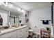 Bathroom featuring dual sinks, granite countertops, tile floors, and a shower at 3018 Corinth Church Rd, Monroe, NC 28112