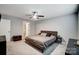 Neutral bedroom offering a ceiling fan, carpet floors, and an adjoining bathroom at 3018 Corinth Church Rd, Monroe, NC 28112