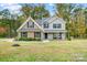 Charming two-story home featuring brick and gray siding, complemented by a well-manicured lawn and mature trees at 3018 Corinth Church Rd, Monroe, NC 28112