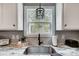 Close-up of a kitchen sink area featuring granite countertops and pendant lighting at 3018 Corinth Church Rd, Monroe, NC 28112