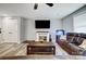 Cozy living room featuring a fireplace, mounted TV, hardwood floors, and comfortable leather furniture at 3018 Corinth Church Rd, Monroe, NC 28112